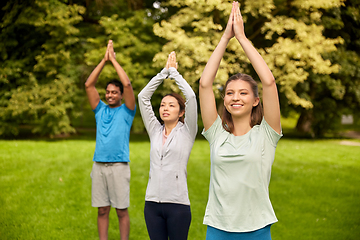 Image showing group of people doing yoga at summer park