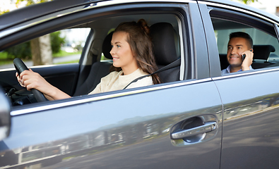 Image showing female driver driving car with male passenger