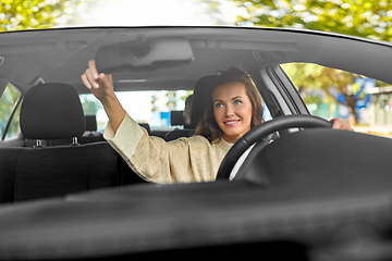 Image showing female driver driving car with male passenger