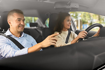 Image showing car driving school instructor teaching woman