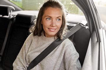 Image showing happy smiling woman or female passenger in car