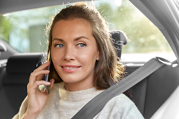 Image showing happy smiling woman in car calling on smartphone