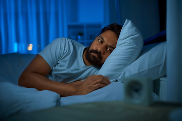 Image showing sleepless indian man lying in bed at night