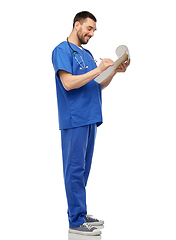 Image showing male doctor writing medical report on clipboard