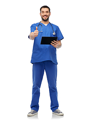 Image showing happy male doctor with tablet pc showing thumbs up