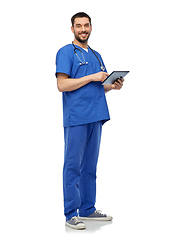 Image showing smiling doctor or male nurse using tablet computer