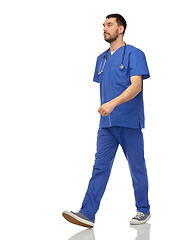 Image showing doctor or male nurse with stethoscope walking