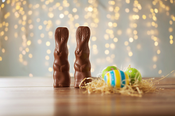 Image showing easter eggs in straw nest and chocolate bunnies
