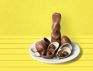 Image showing chocolate bunny, eggs and candies on white plate