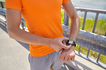 Image showing close up of man with fitness tracker outdoors