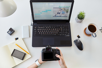 Image showing woman with camera and video editor on laptop