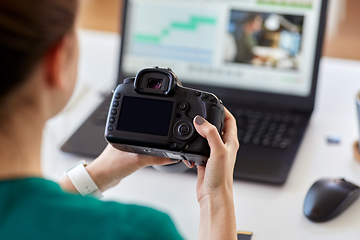 Image showing woman with camera and video editor on laptop