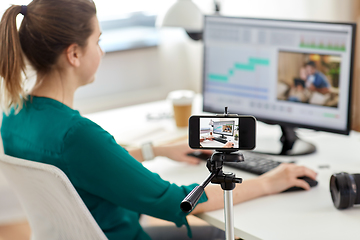 Image showing smartphone recording woman working in video editor