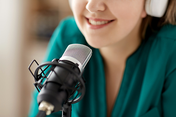 Image showing woman with microphone recording podcast at studio