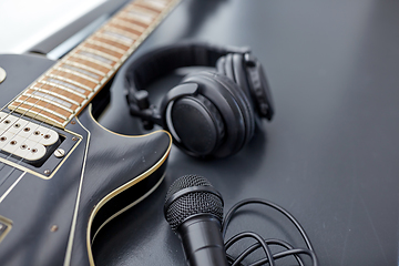 Image showing close up of bass guitar, microphone and headphones