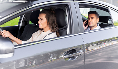 Image showing female driver driving car with male passenger