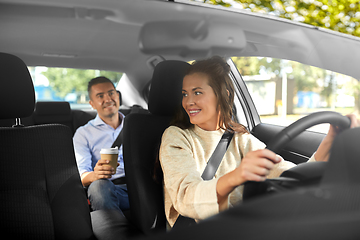 Image showing female driver driving car with male passenger