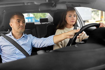 Image showing car driving school instructor teaching woman