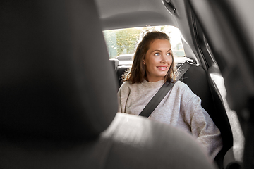 Image showing happy smiling woman or female passenger in car