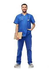 Image showing smiling doctor in blue uniform with clipboard