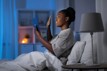 Image showing woman with tablet pc having video call in bed