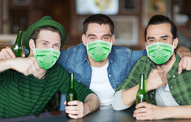 Image showing male friends in masks drinking beer at bar or pub