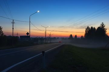 Image showing Night Country Highway Illuminated by Street Lamps at Sunset