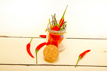 Image showing red chili peppers on a glass jar