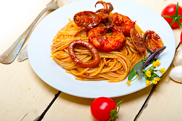 Image showing Italian seafood spaghetti pasta on red tomato sauce