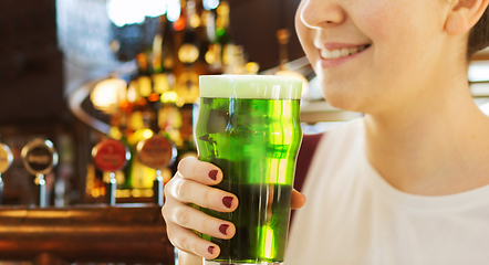 Image showing close up of woman with green beer in glass