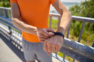 Image showing close up of man with fitness tracker outdoors