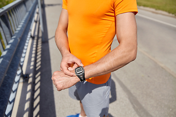 Image showing close up of man with fitness tracker outdoors