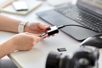 Image showing woman with sd card reader and laptop at office