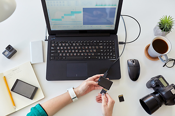 Image showing woman with sd card reader and laptop at office