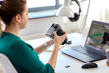 Image showing woman with camera and video editor on laptop