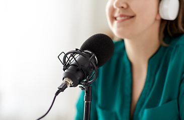 Image showing woman with microphone recording podcast at studio