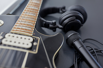 Image showing close up of bass guitar, microphone and headphones