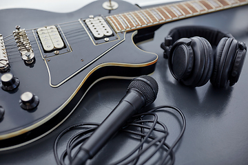 Image showing close up of bass guitar, microphone and headphones