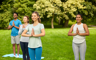 Image showing group of people doing yoga at summer park