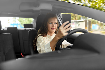 Image showing woman or driver driving car and taking selfie