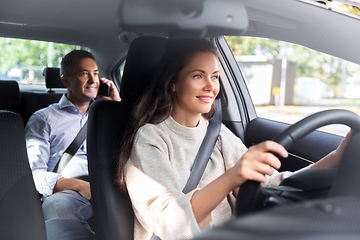 Image showing female driver driving car with male passenger