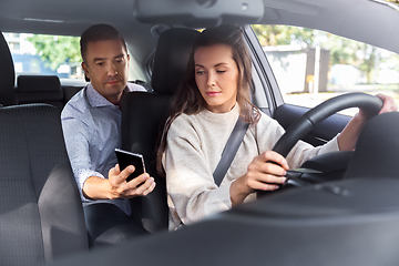 Image showing female driver driving car with male passenger