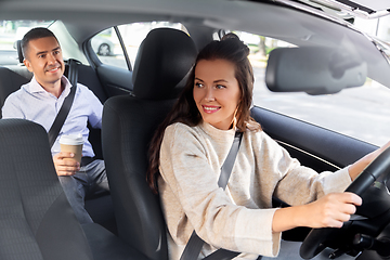 Image showing female driver driving car with male passenger