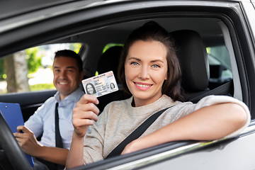 Image showing car driving instructor and driver with license