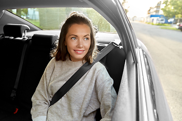 Image showing happy smiling woman or female passenger in car