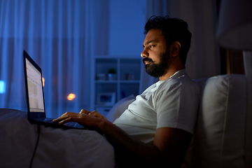 Image showing indian man with laptop in bed at home at night