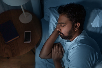 Image showing indian man sleeping in bed at home at night