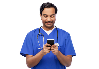 Image showing smiling doctor or male nurse using smartphone