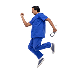 Image showing doctor or male nurse with stethoscope jumping