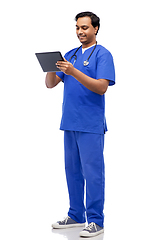 Image showing smiling doctor or male nurse using tablet computer